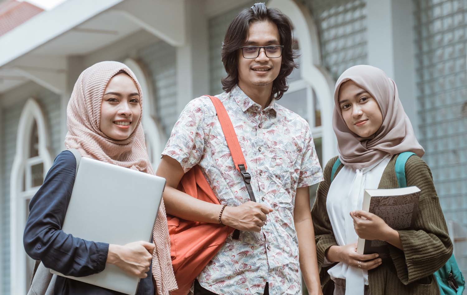 portrait-three-Indonesian-students-looking-front-campus-yard
