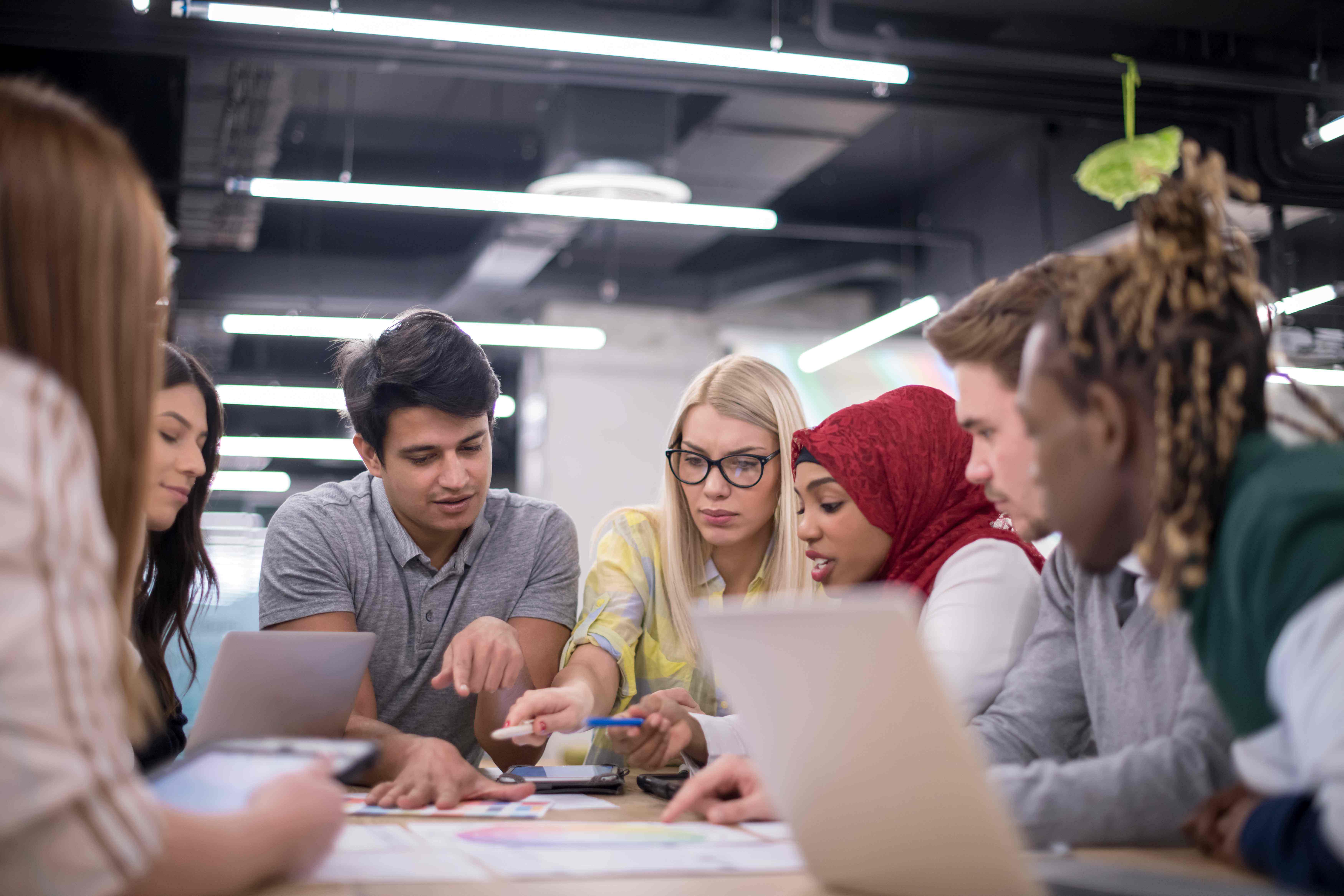 group of students working together around the desk